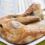 Closeup of delicious Mexican plate of chile rellenos on green table