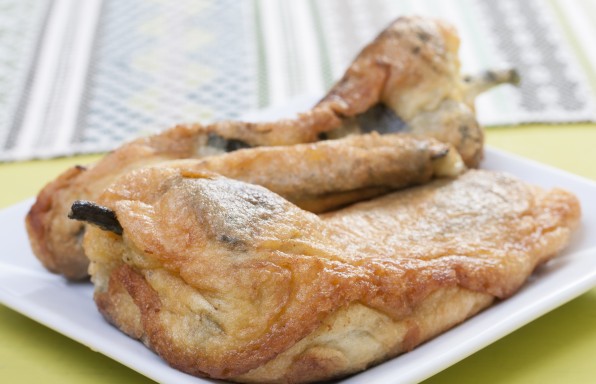 Closeup of delicious Mexican plate of chile rellenos on green table