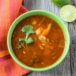 Tortilla Soup with fresh lime and cilantro on Rustic Wood Background