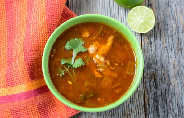 Tortilla Soup with fresh lime and cilantro on Rustic Wood Background